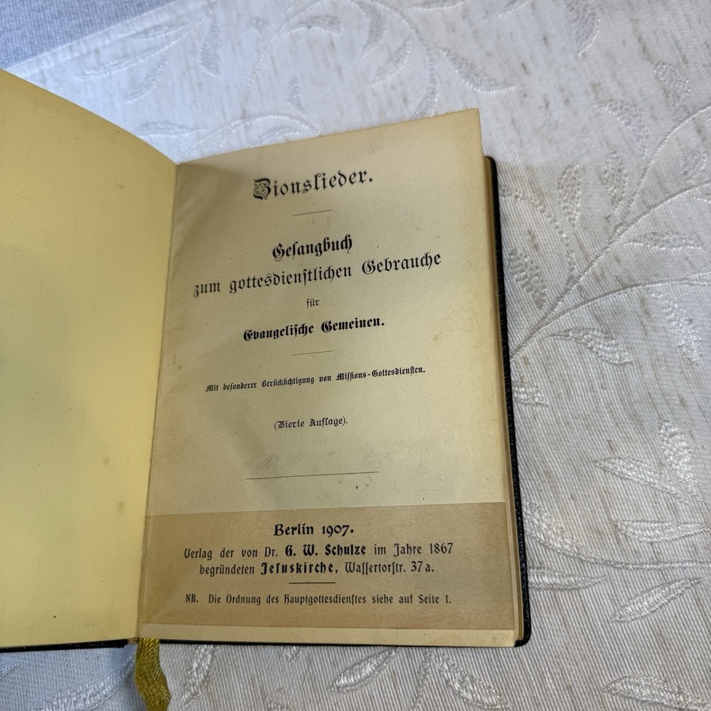 Antique German hymnal songbook titled "Zionslieder" (Songs of Zion). 1907